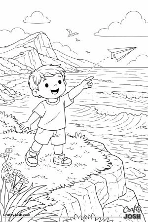 A young boy stands on a grassy cliff flying a paper plane as ocean waves roll below and clouds float in the sky