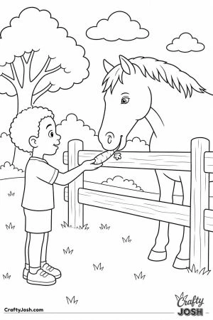 Boy feeding a horse a carrot over the fence
